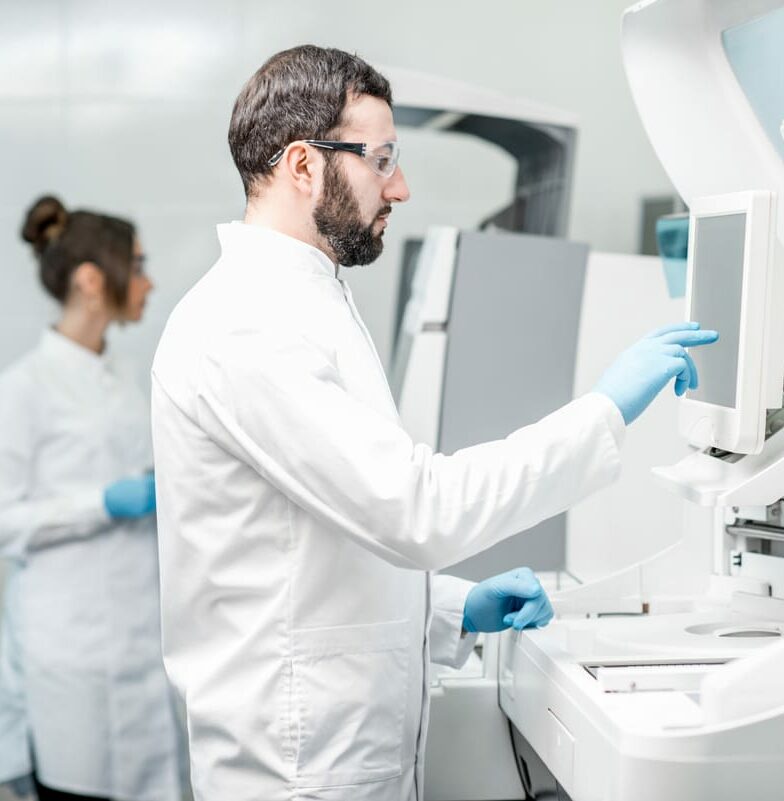Scientists in a laboratory working with high-precision equipment for global temperature-controlled logistics