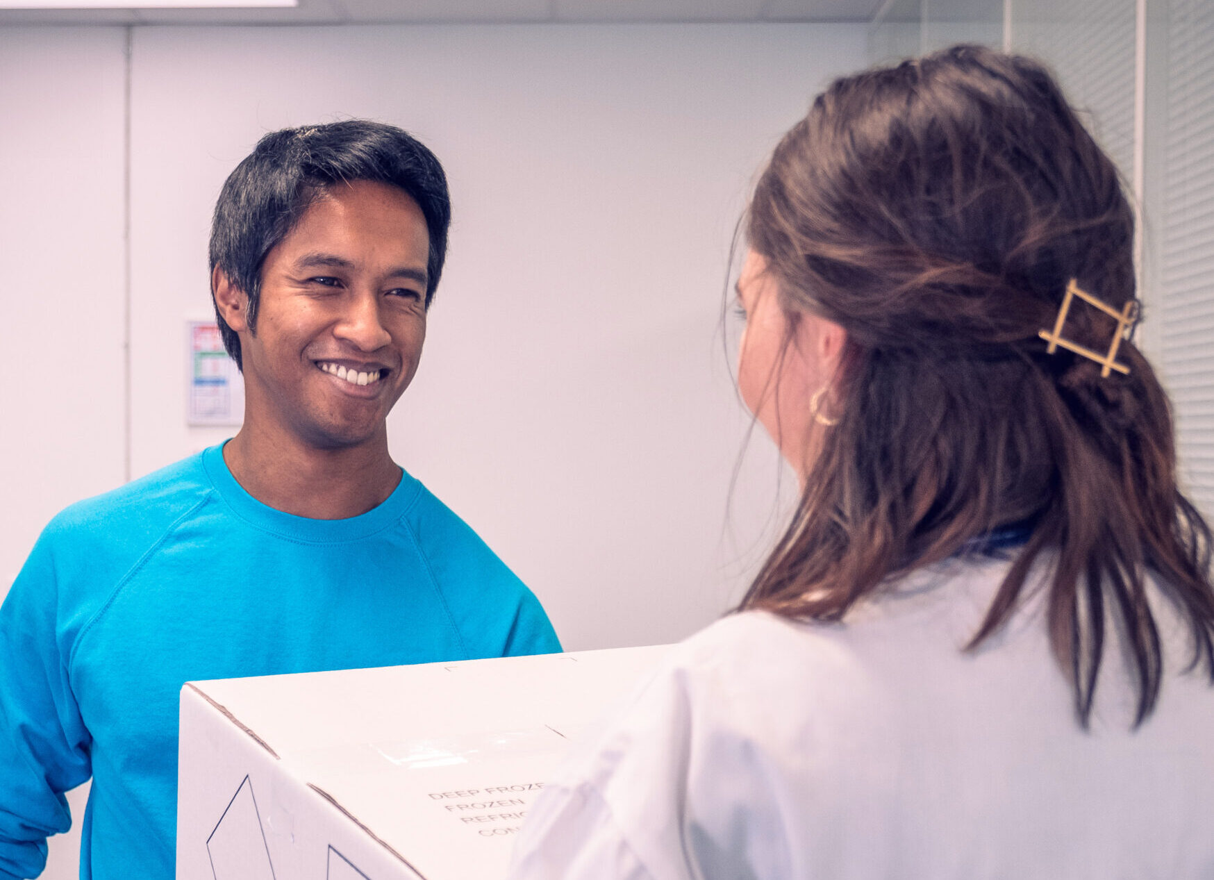 CRYOPDP courier delivering a clinical package to a healthcare professional, illustrating white gloves service with a human touch.