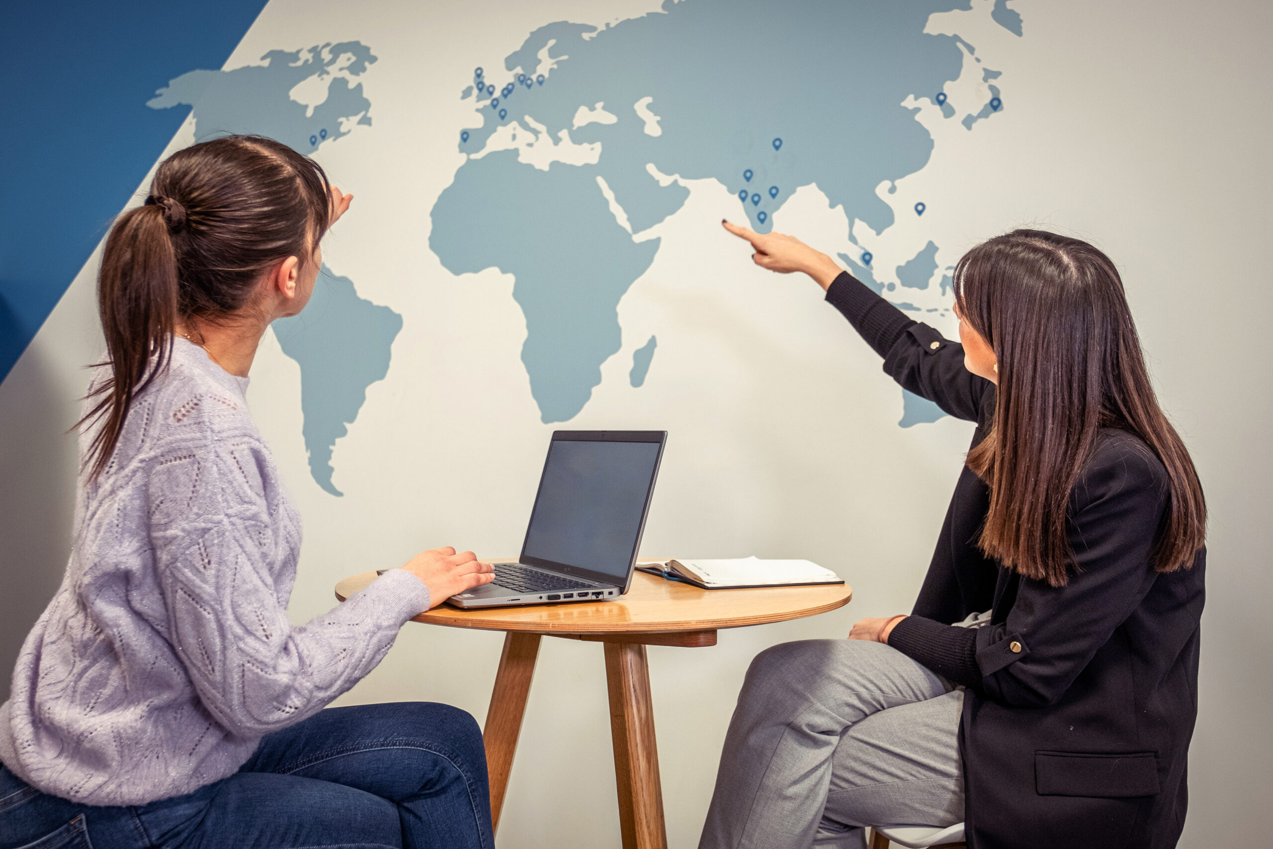 CRYOPDP team members reviewing a global map, planning secure and time-critical routes for Onboard Courier shipments.