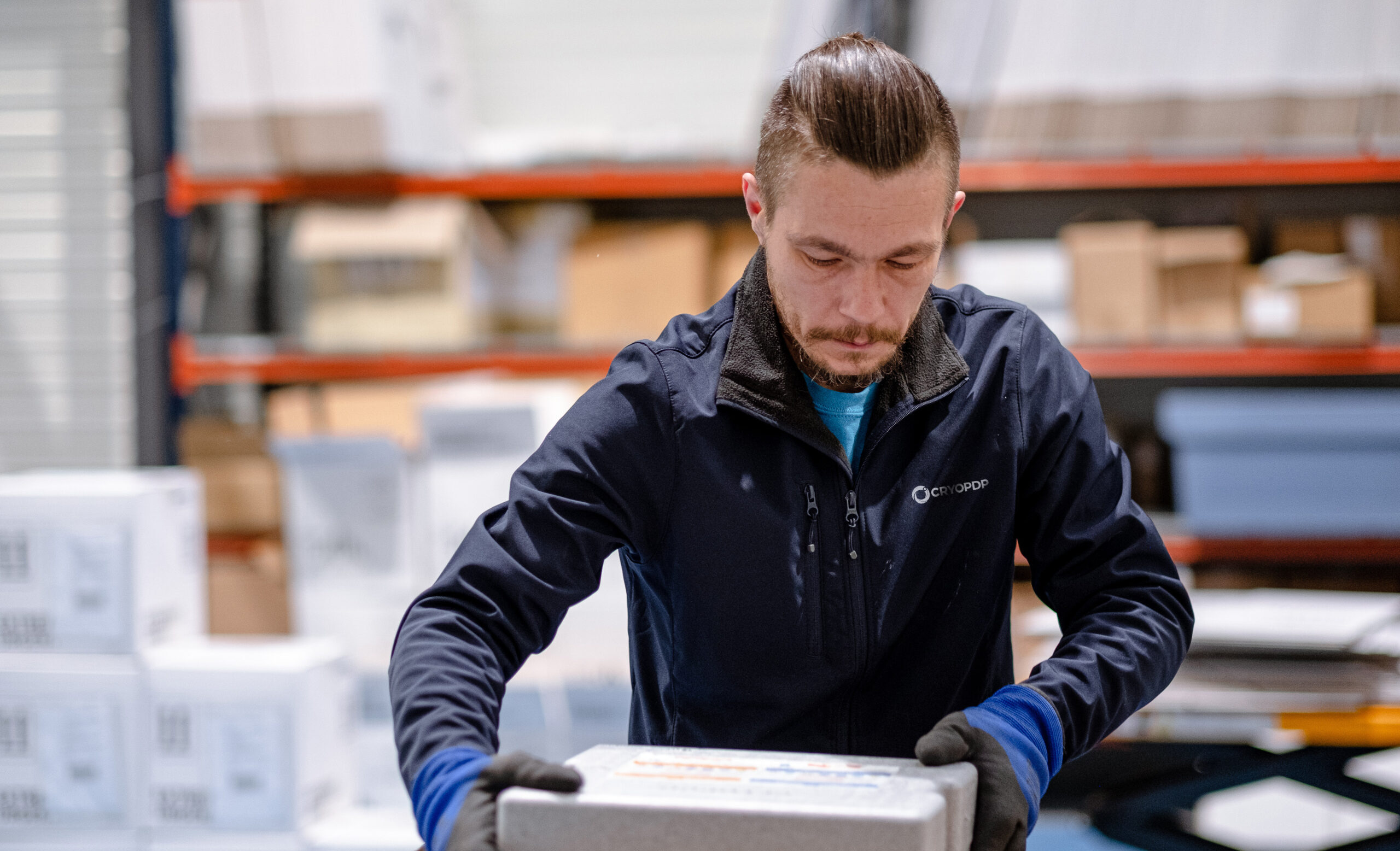 CRYOPDP team member handling a package inside a warehouse as part of our solutions