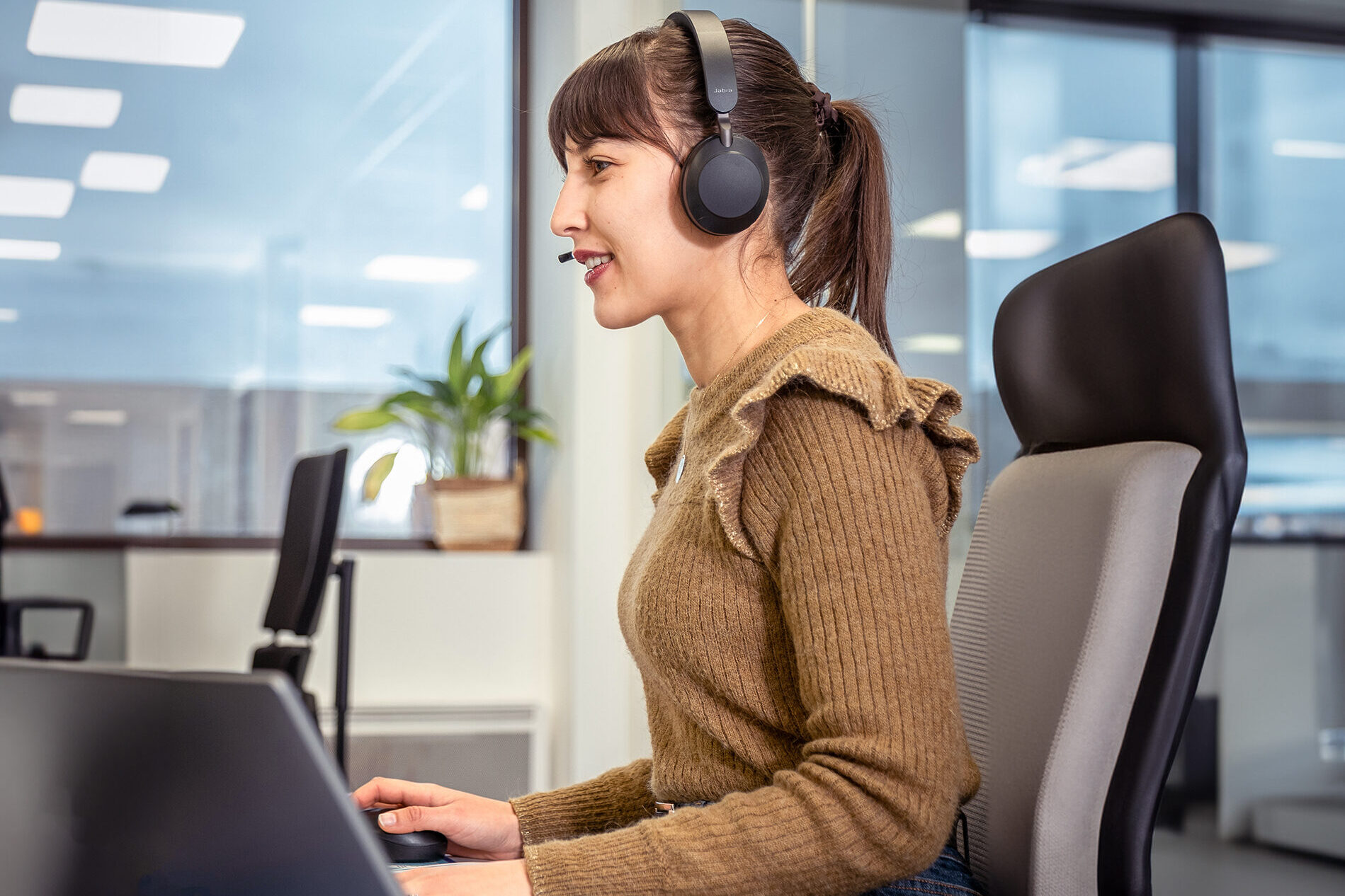 Customer service representative wearing a headset, supporting clients in pharmaceutical logistics operations.