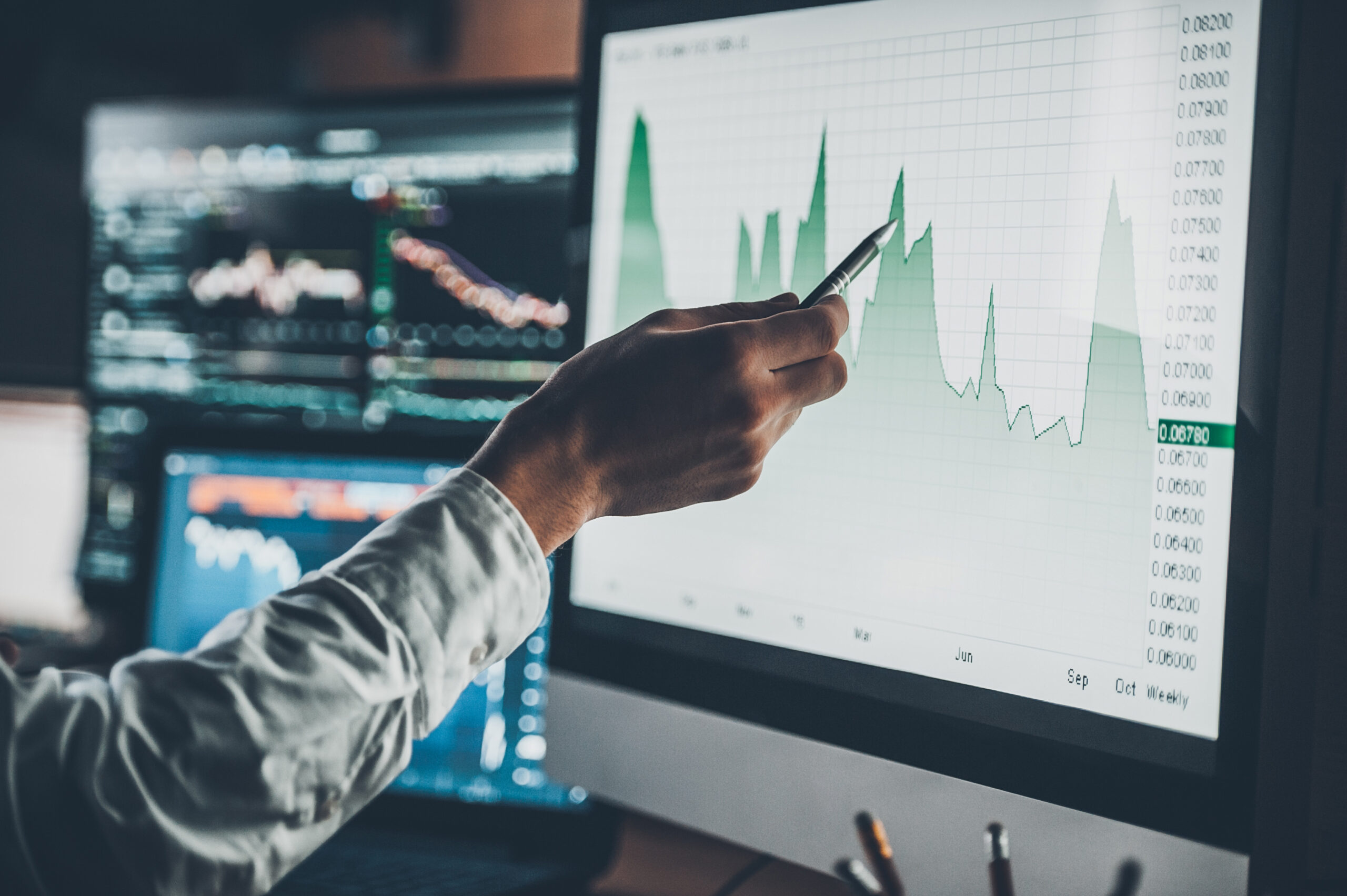 Professional reviewing market data on screen, symbolising control, timing, and accuracy in pharmaceutical logistics.