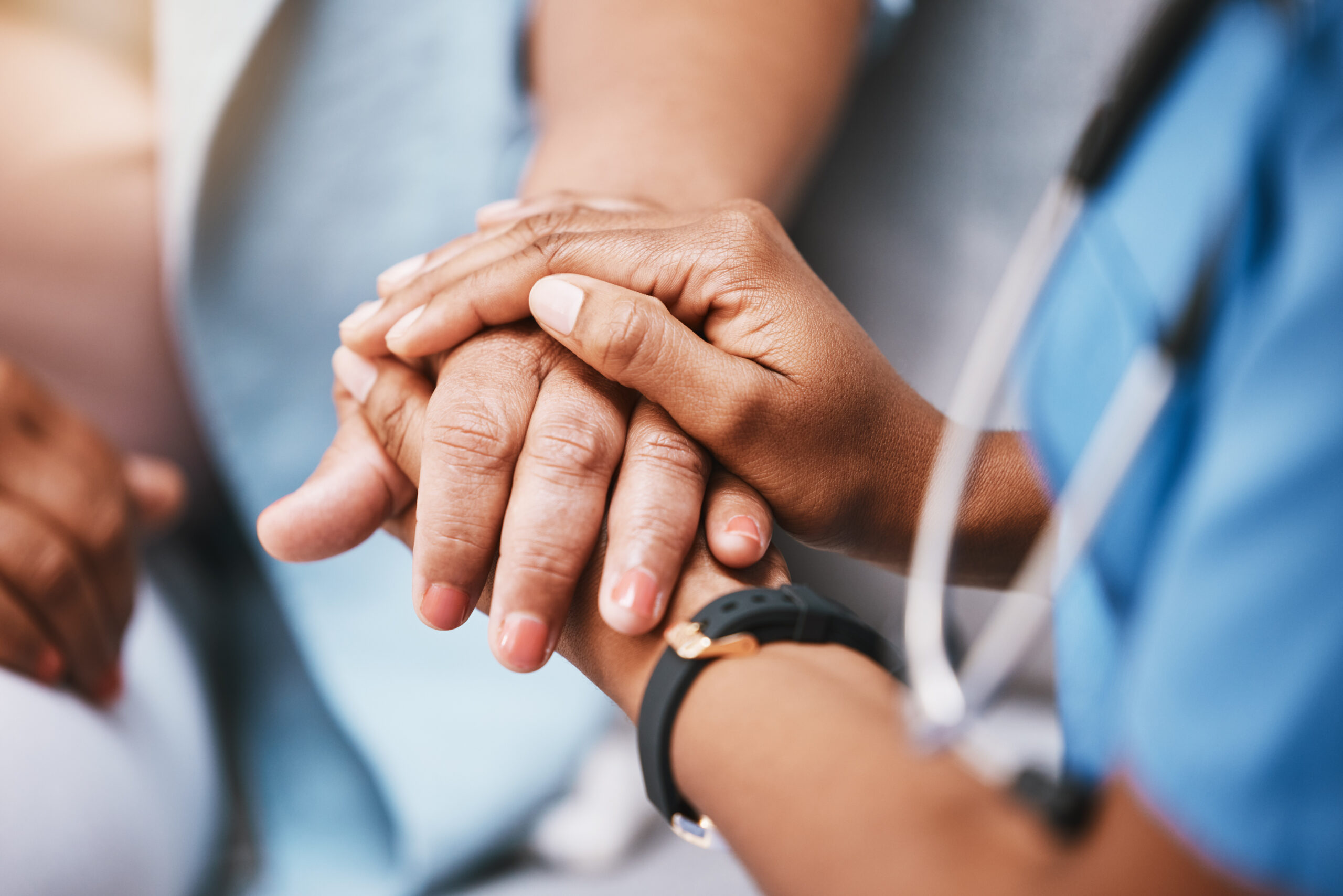 CRYOPDP healthcare professional holding a patient’s hand in a gesture of care and reassurance