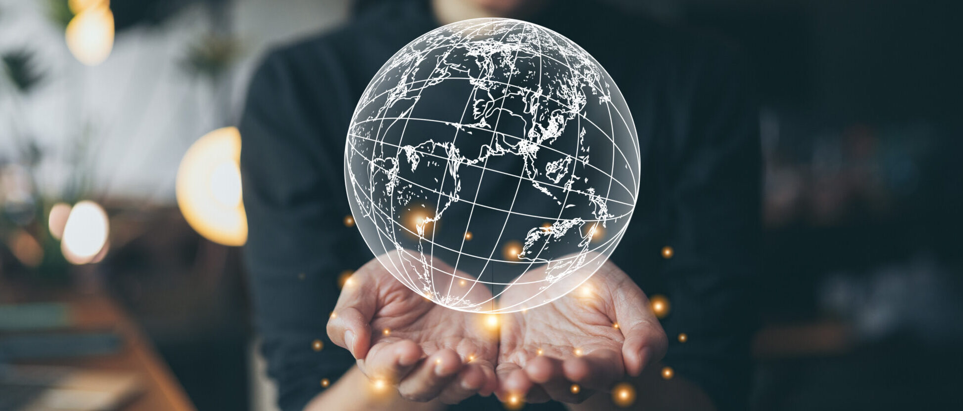 Hands presenting a digital globe, symbolising CRYOPDP’s global coordination in clinical trial logistics solutions.