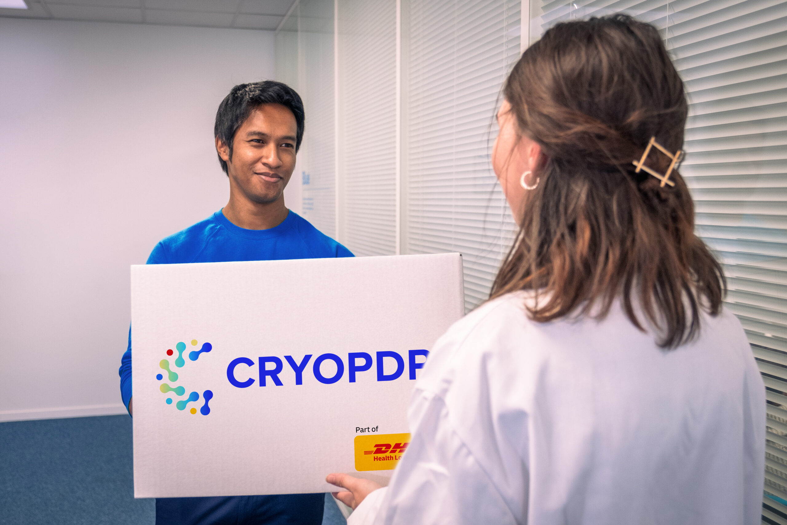 CRYOPDP courier delivering a high-priority shipment to a healthcare professional, illustrating the Onboard Courier service in action.