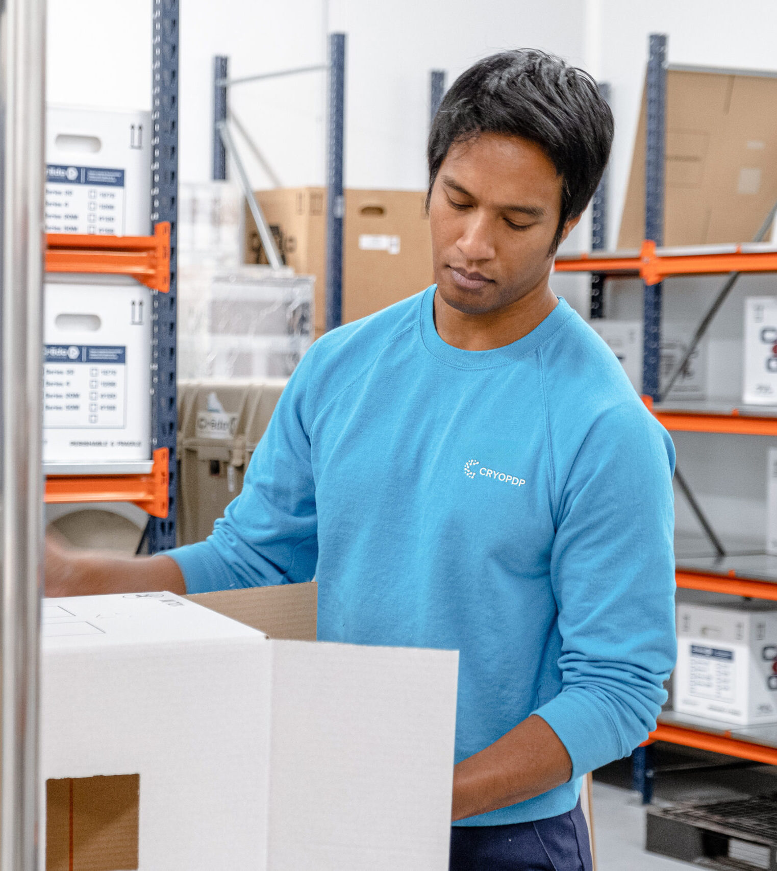 CRYOPDP team member preparing packaging in a controlled facility as part of a Pick & Pack logistics process.