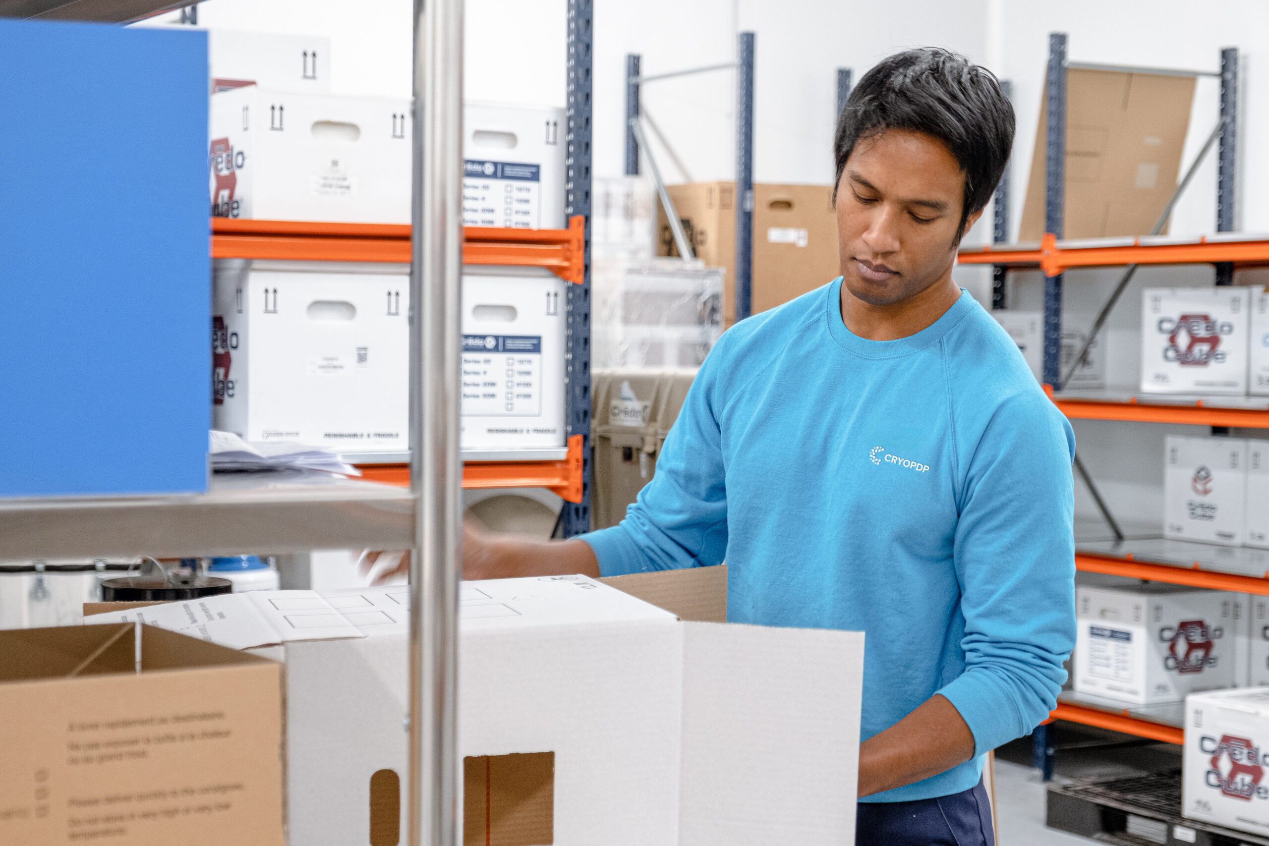 CRYOPDP technician preparing high-priority shipments, representing the hands-on process behind Onboard Courier services.