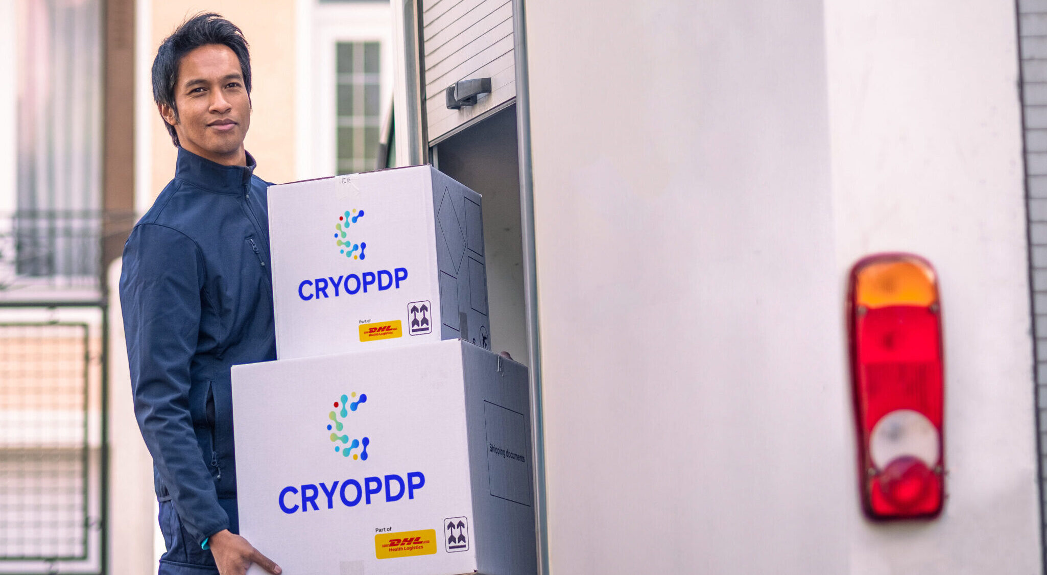 CRYOPDP team member loading labelled cold chain boxes into a vehicle