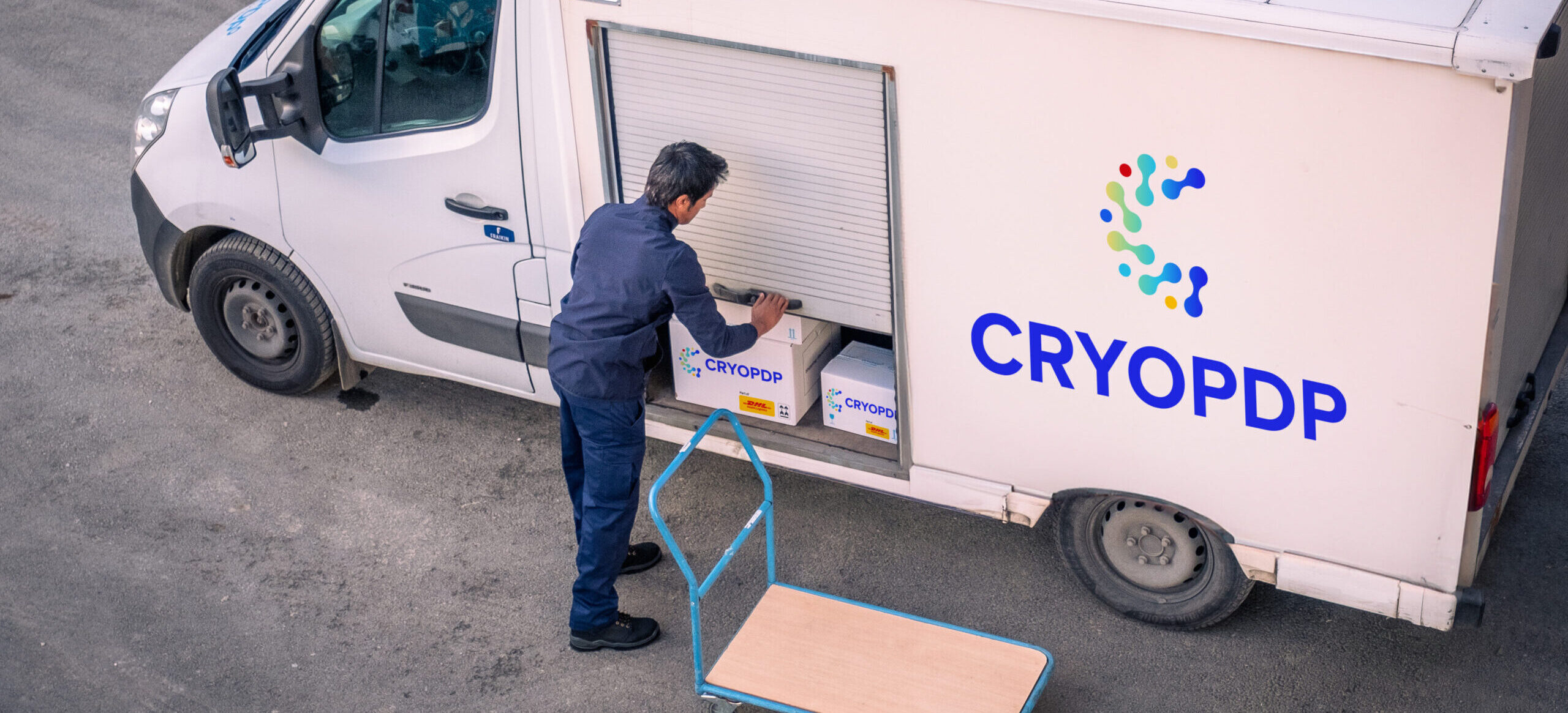 CRYOPDP team member loading parcels into a temperature-controlled vehicle for logistics network.