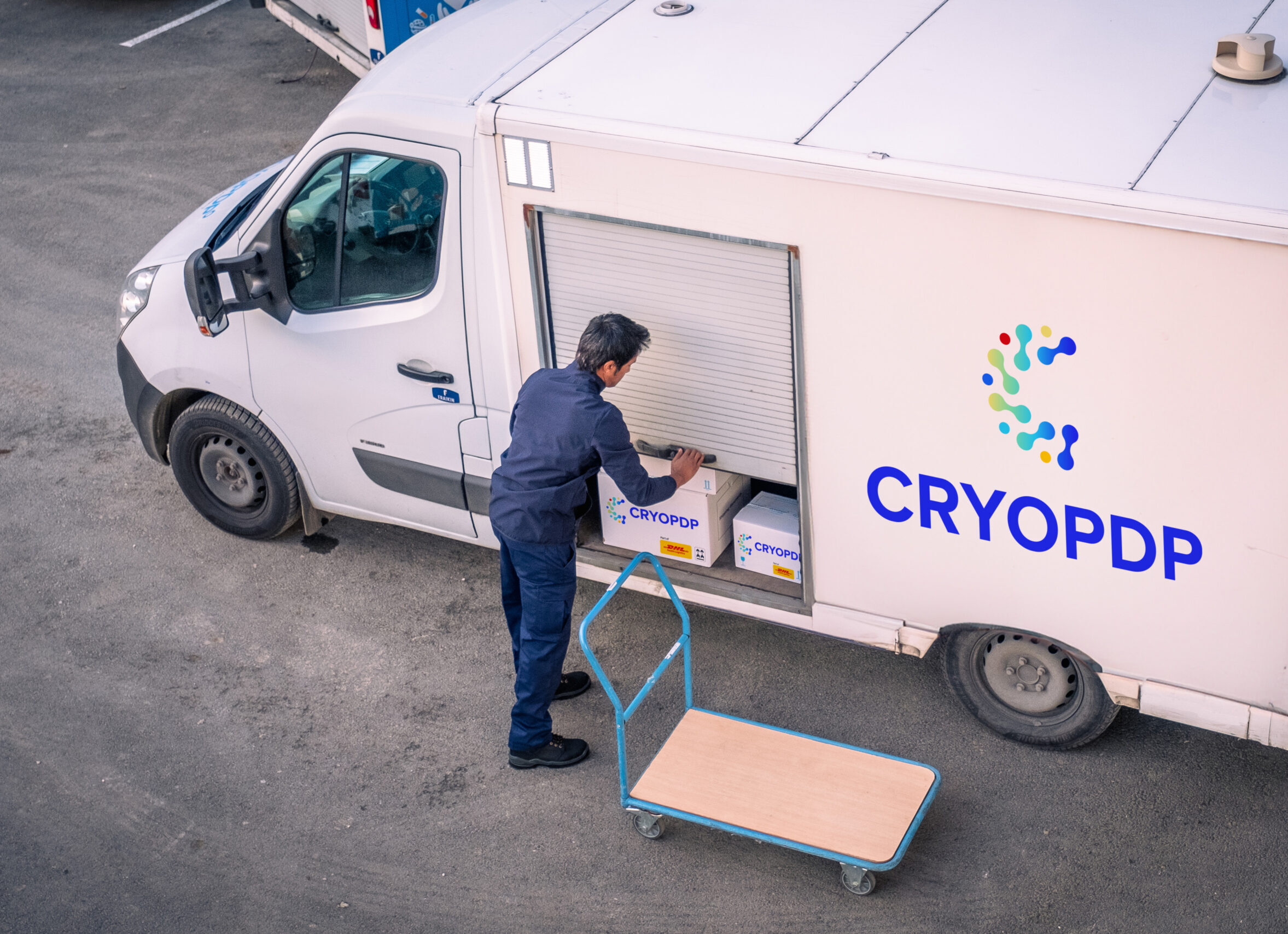 CRYOPDP courier unloading temperature-controlled boxes from a delivery van, demonstrating white gloves handling in healthcare logistics.
