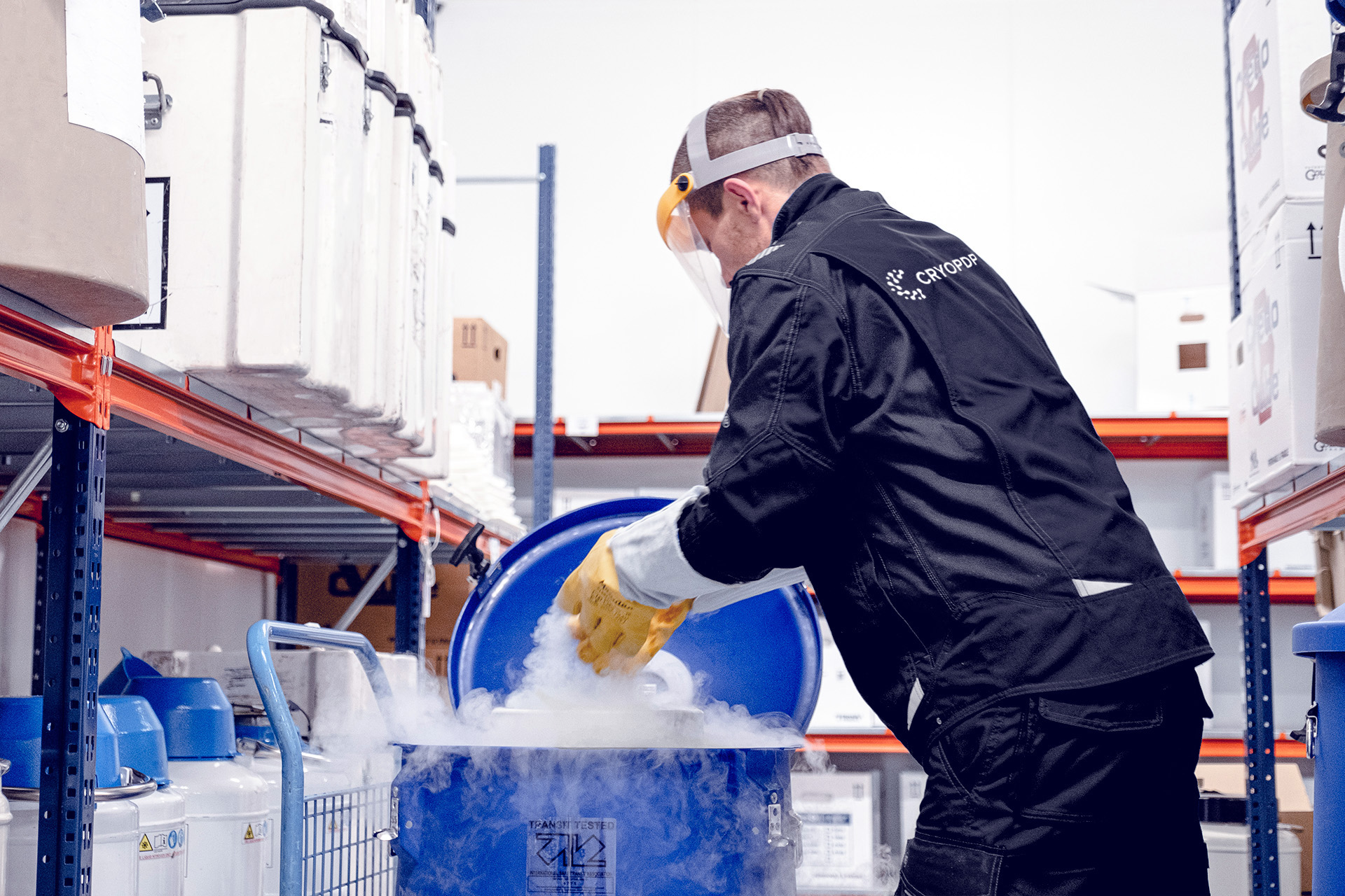 CRYOPDP technician preparing a shipment with cold chain materials, supporting the secure handling process for Onboard Courier deliveries.