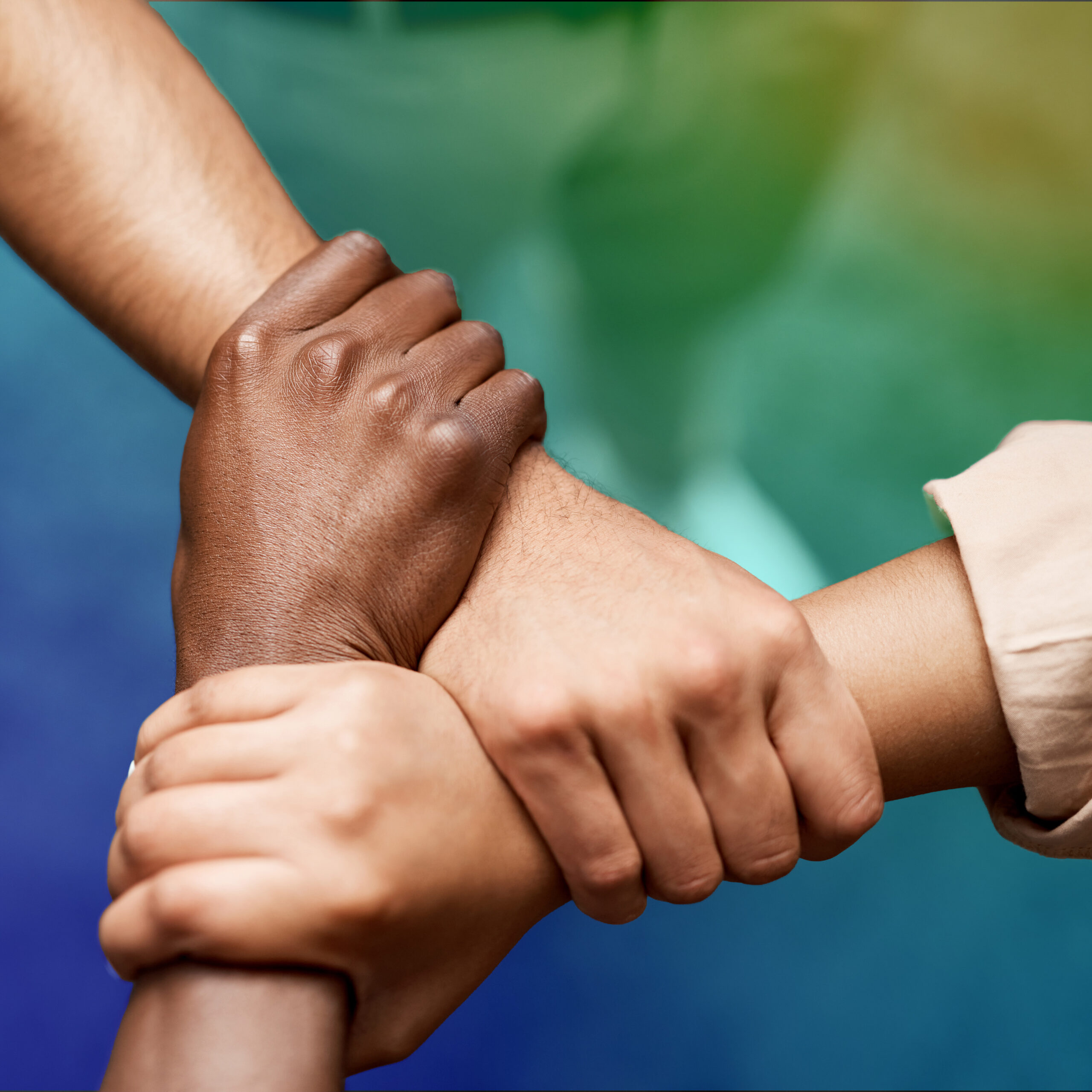 Four hands joined together symbolising unity trust and collaboration in CRYOPDP’s global healthcare logistics.