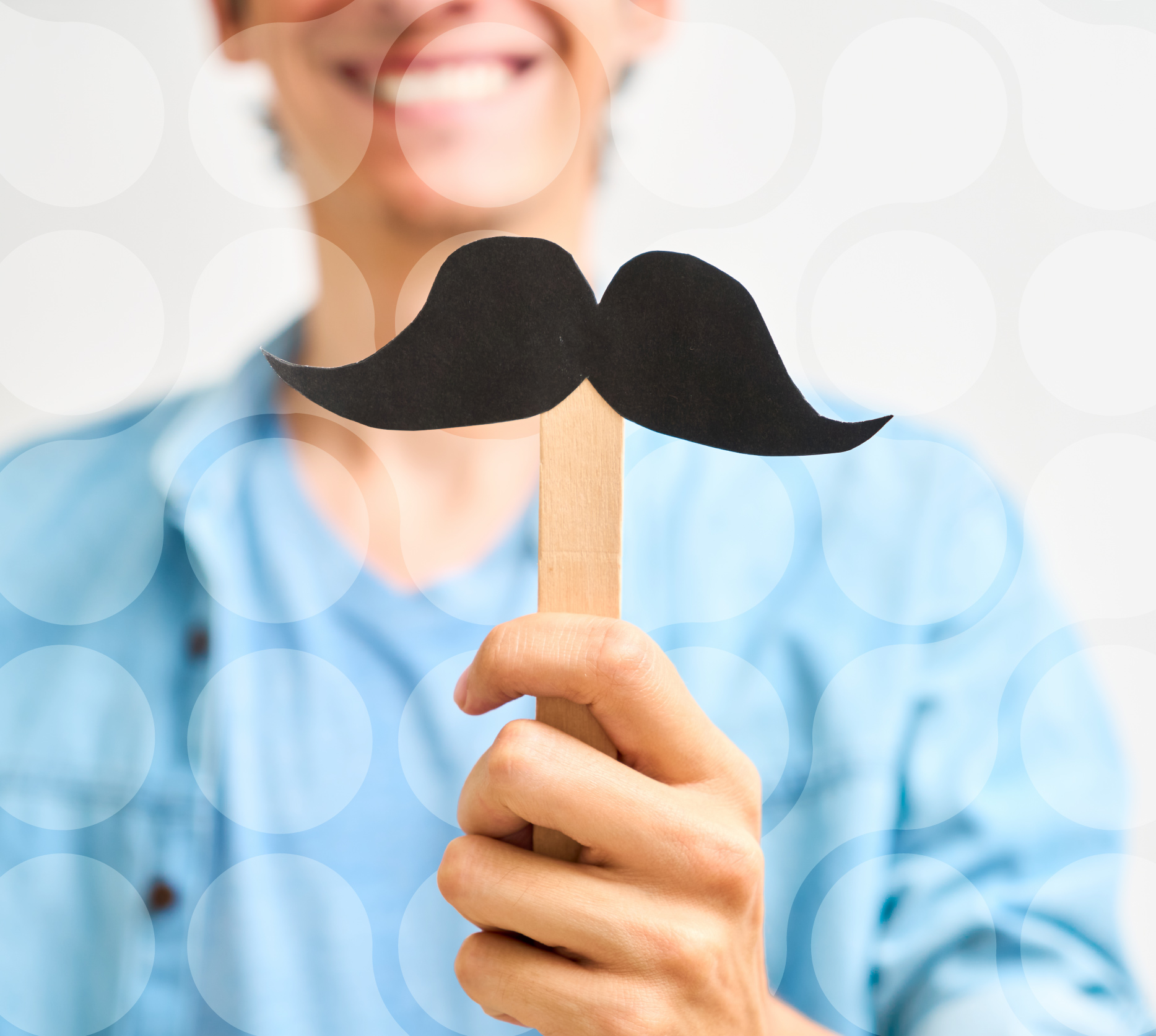 Person holding a paper moustache on a stick.